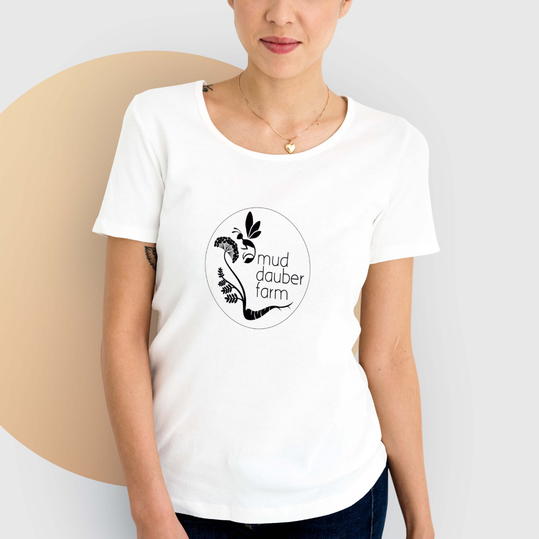 Woman wearing a white t-shirt with Mud Dauber Farm logo.